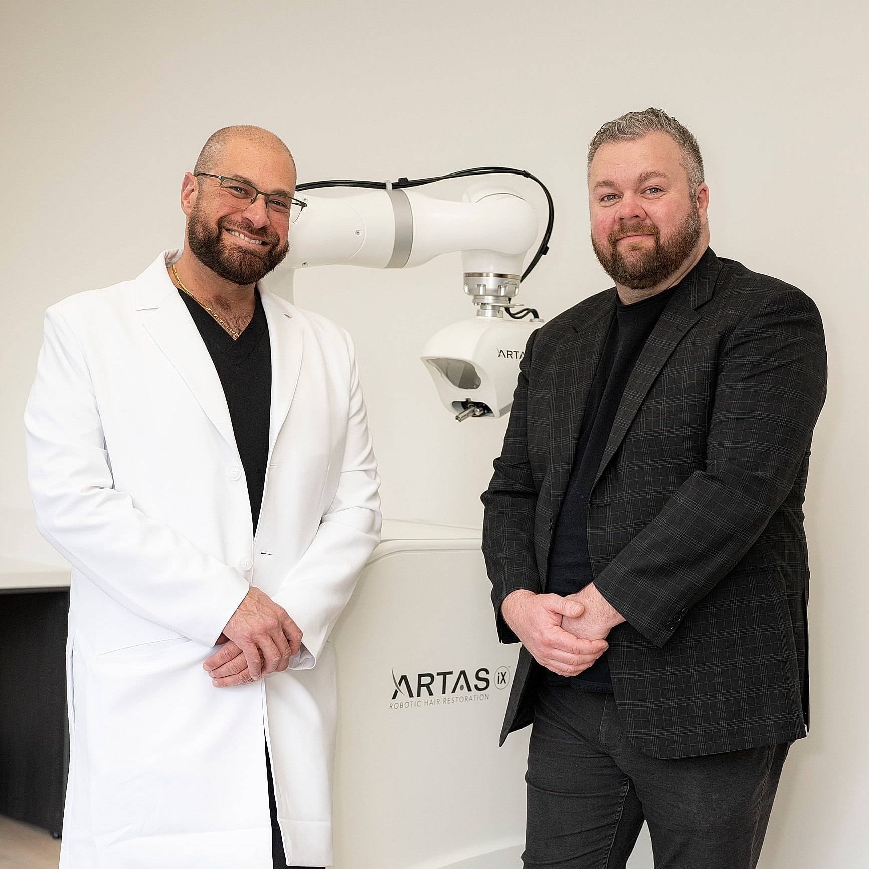 Doctors posing with ARTAS robotic hair restoration system