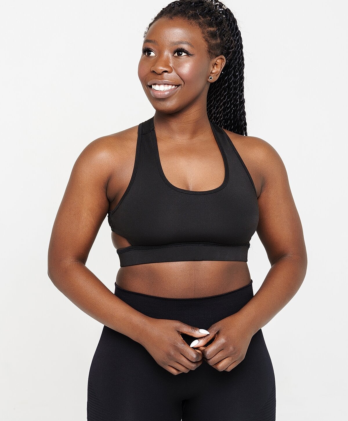 Smiling woman in sporty black outfit.