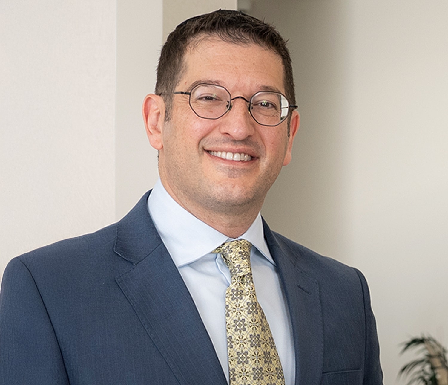 Professional man smiling in business attire.