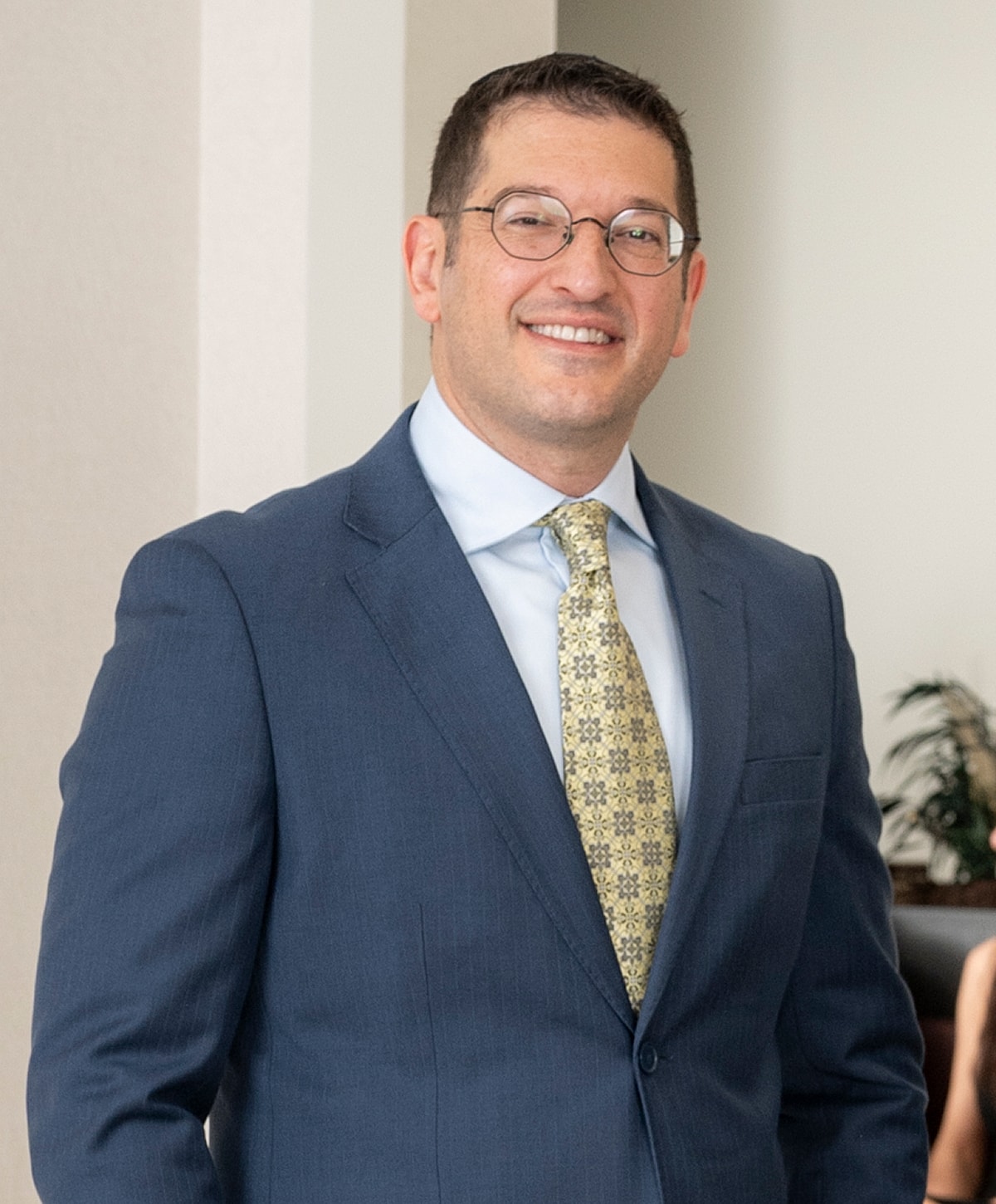 Smiling man in a suit with glasses