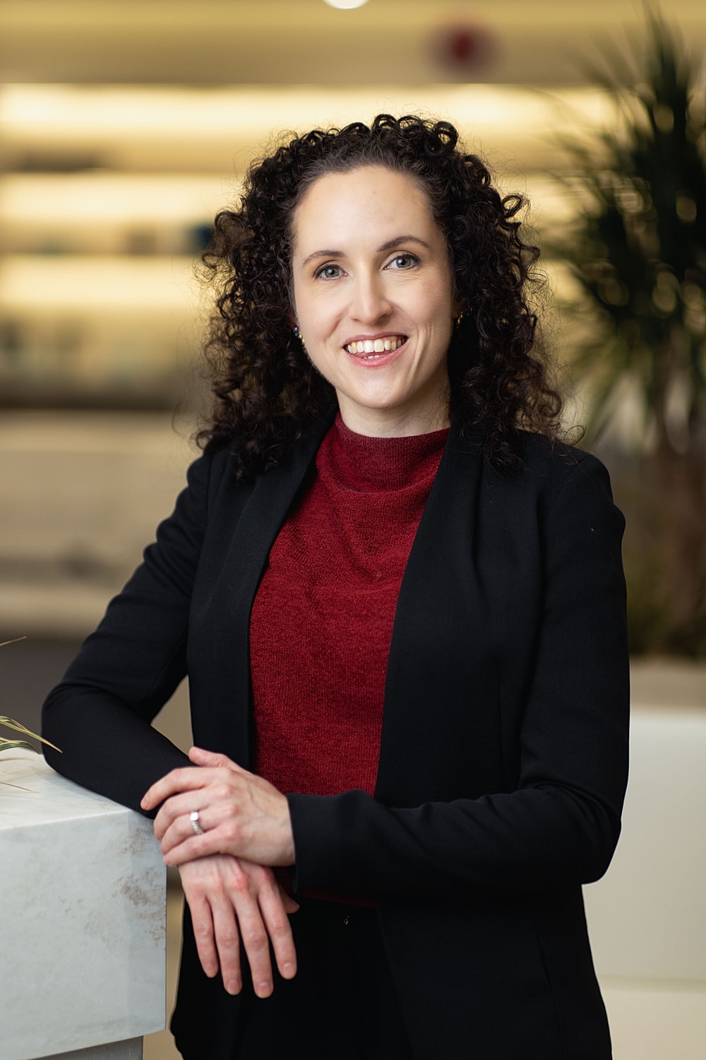 Professional woman smiling in office setting.