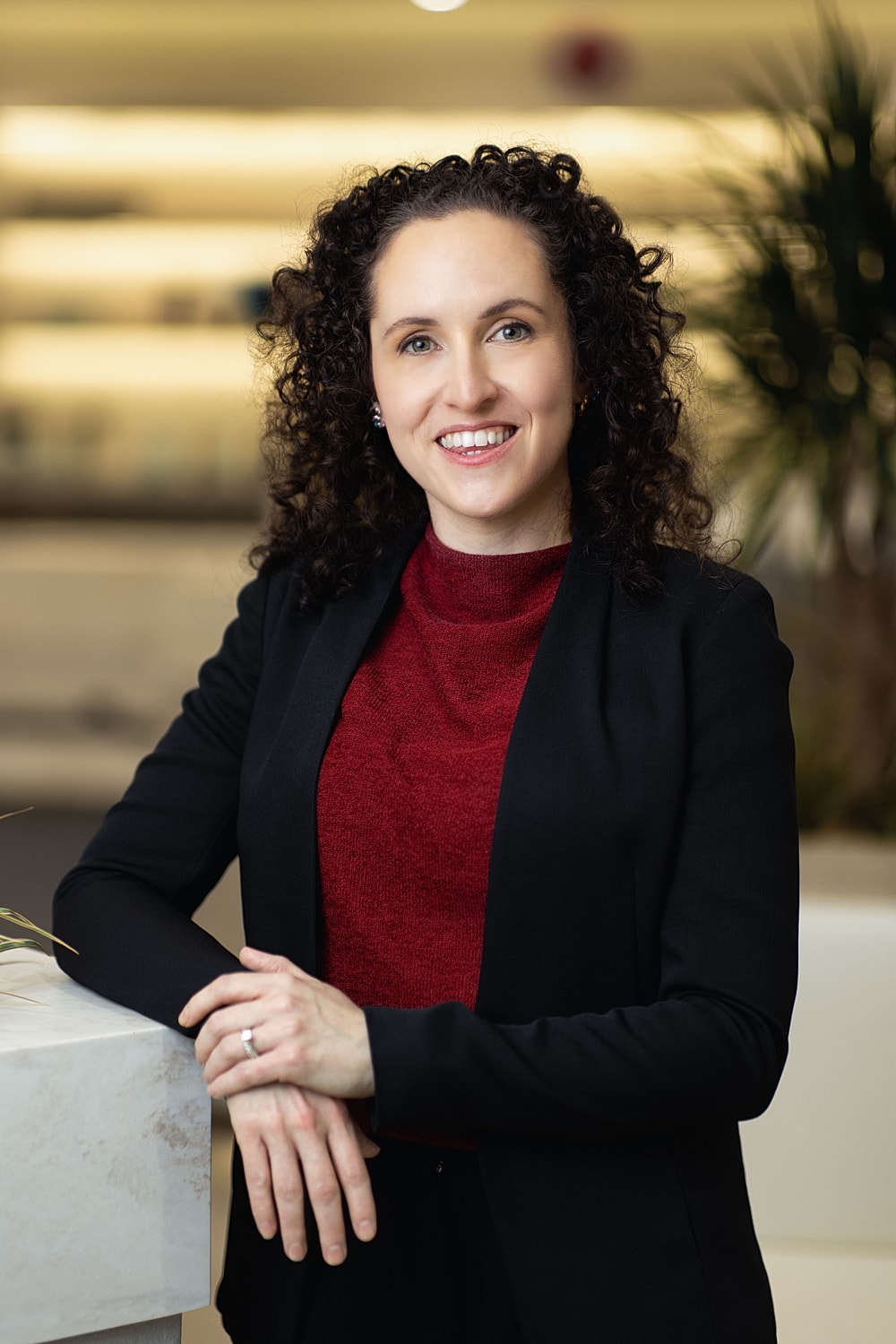 Professional woman smiling in modern office setting.
