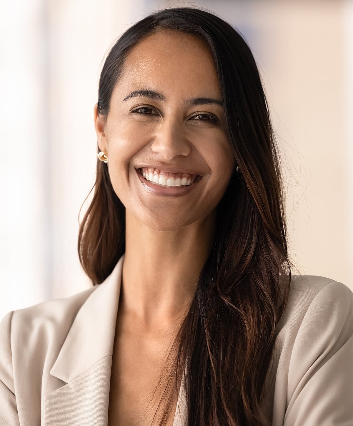 Smiling woman in professional attire, close-up portrait.