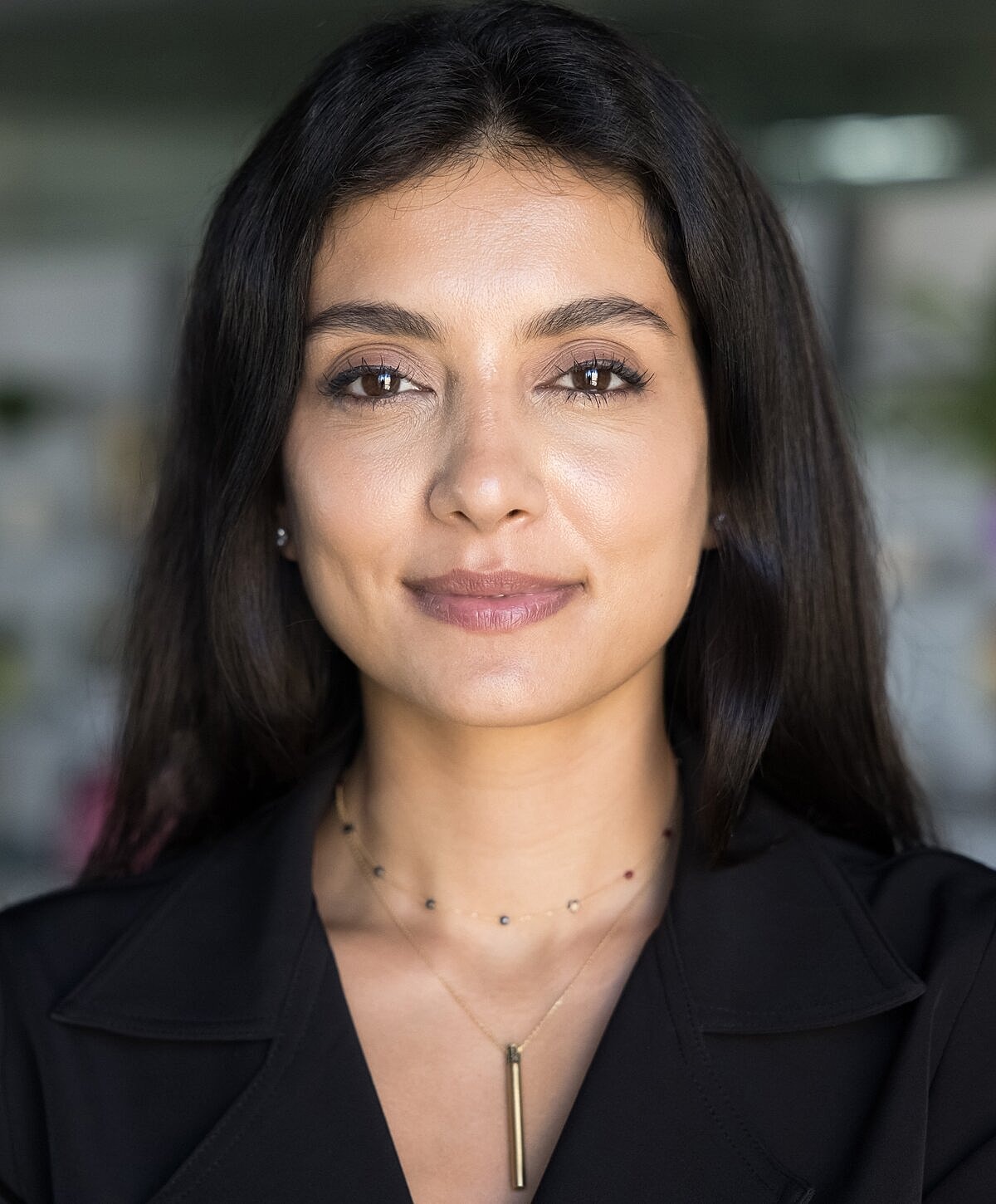 Portrait of a confident woman in black attire.