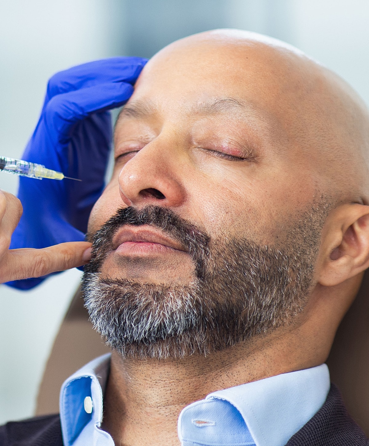 Man receiving a cosmetic injection treatment.