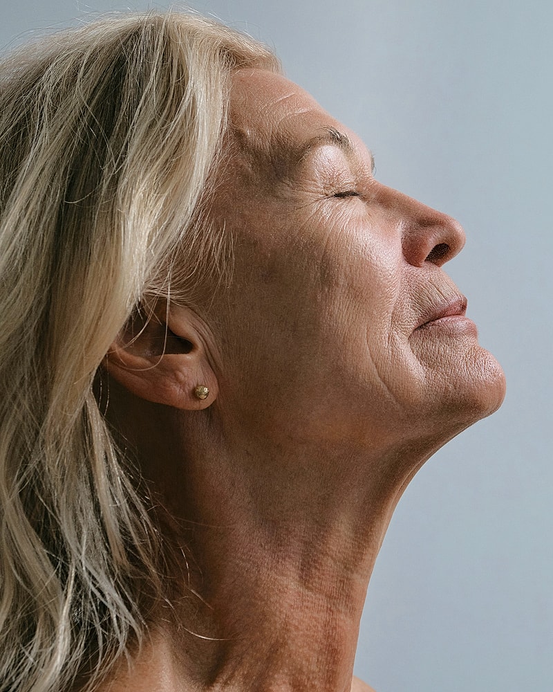 Profile portrait of a serene older woman.