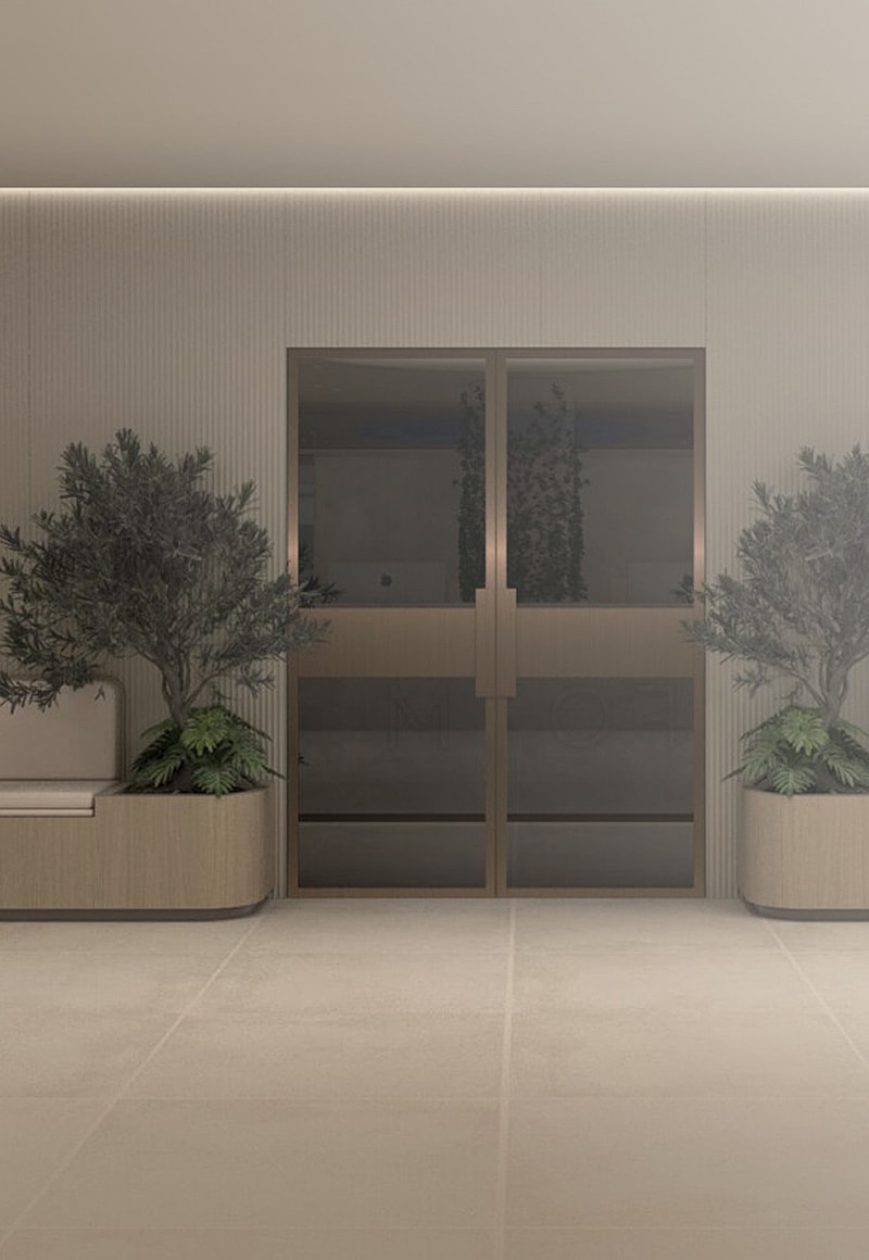 Modern entryway with plants and glass doors.