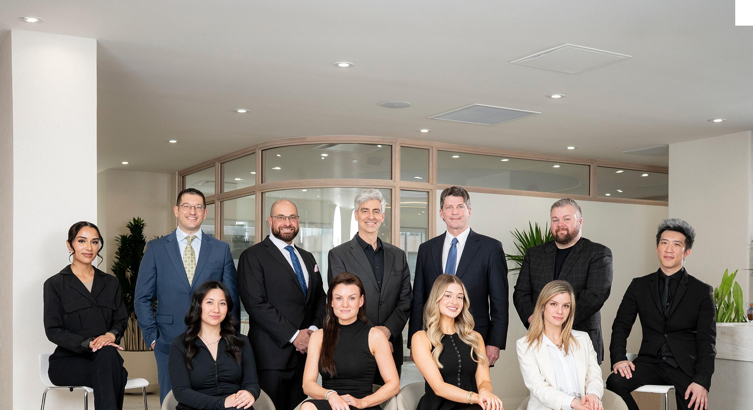 Professional group photo in modern office setting.