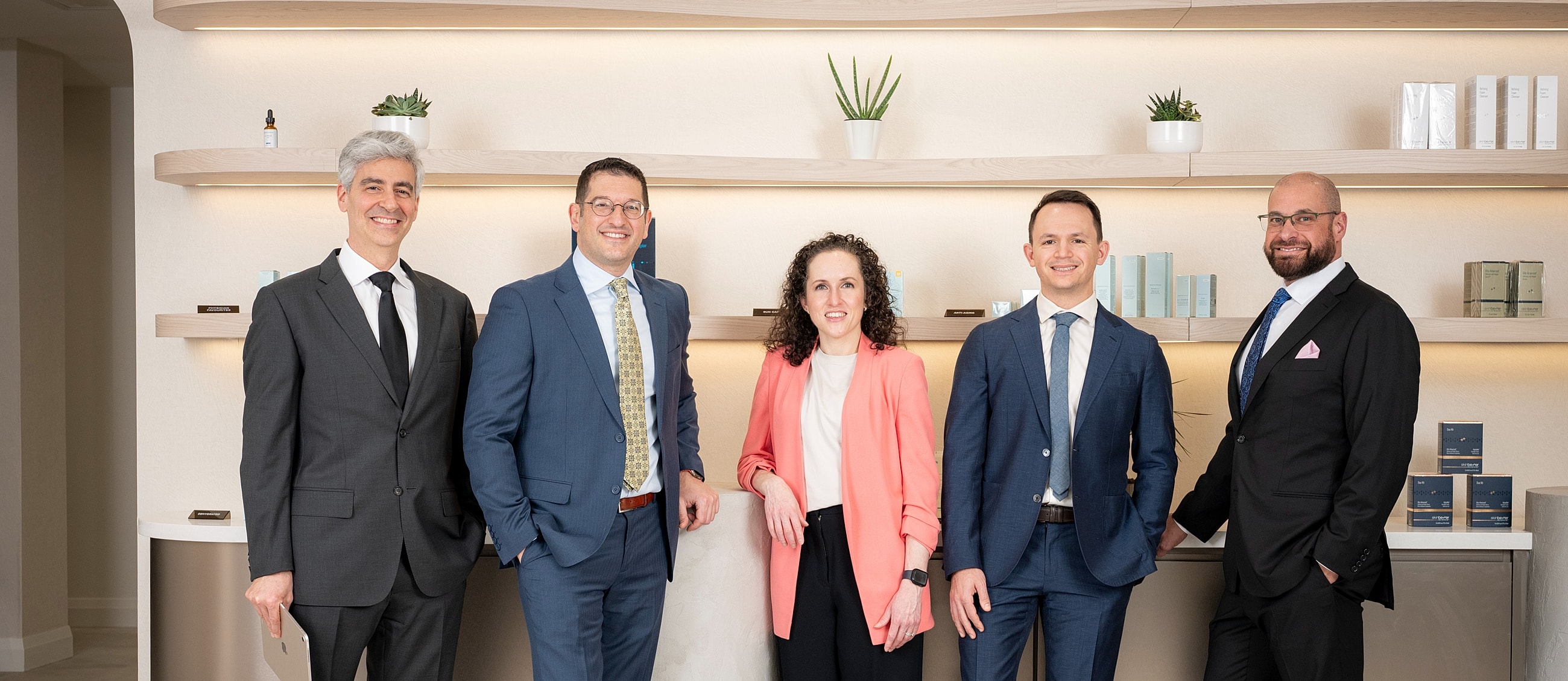 Professional team posing in modern office setting.