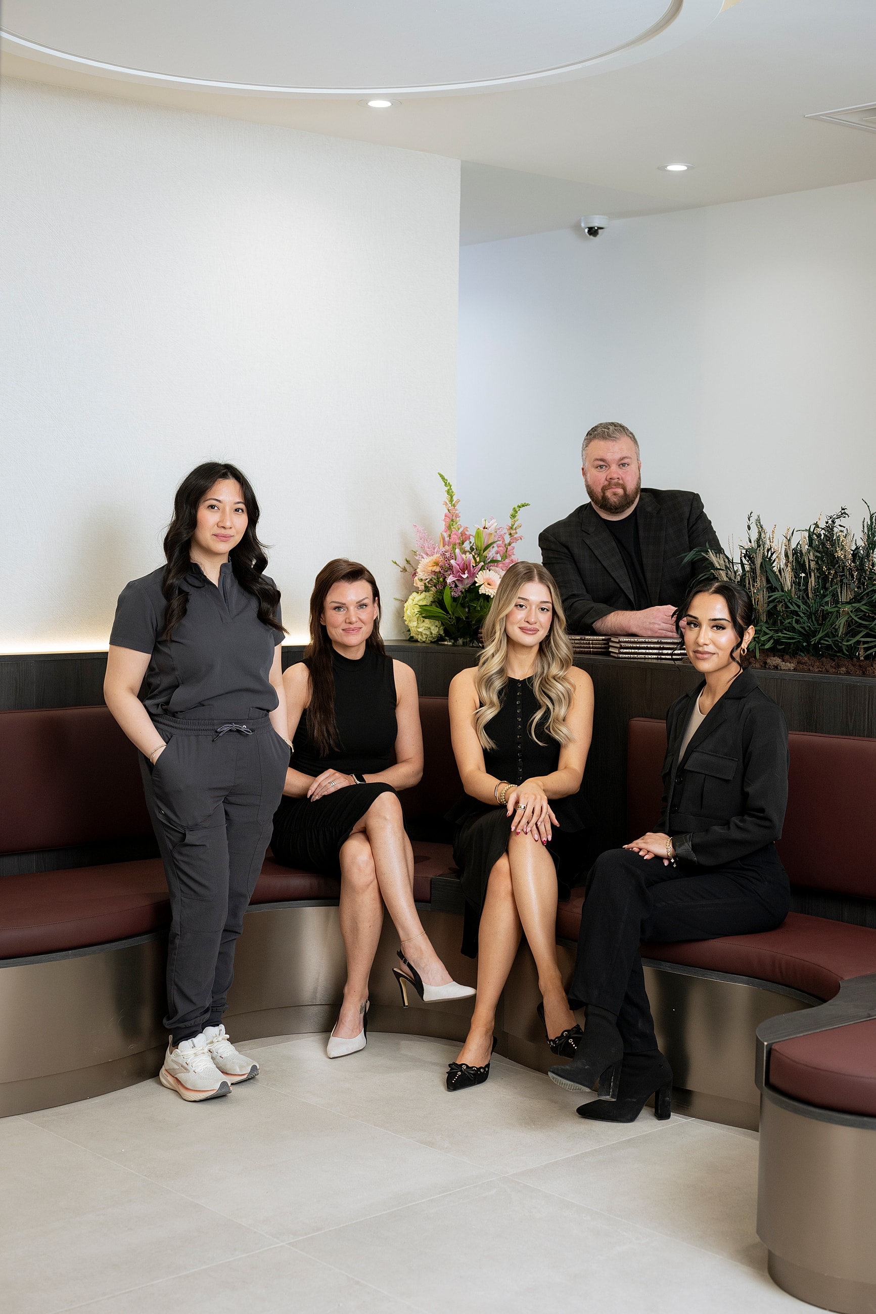 Group of professionals posing together in office setting.