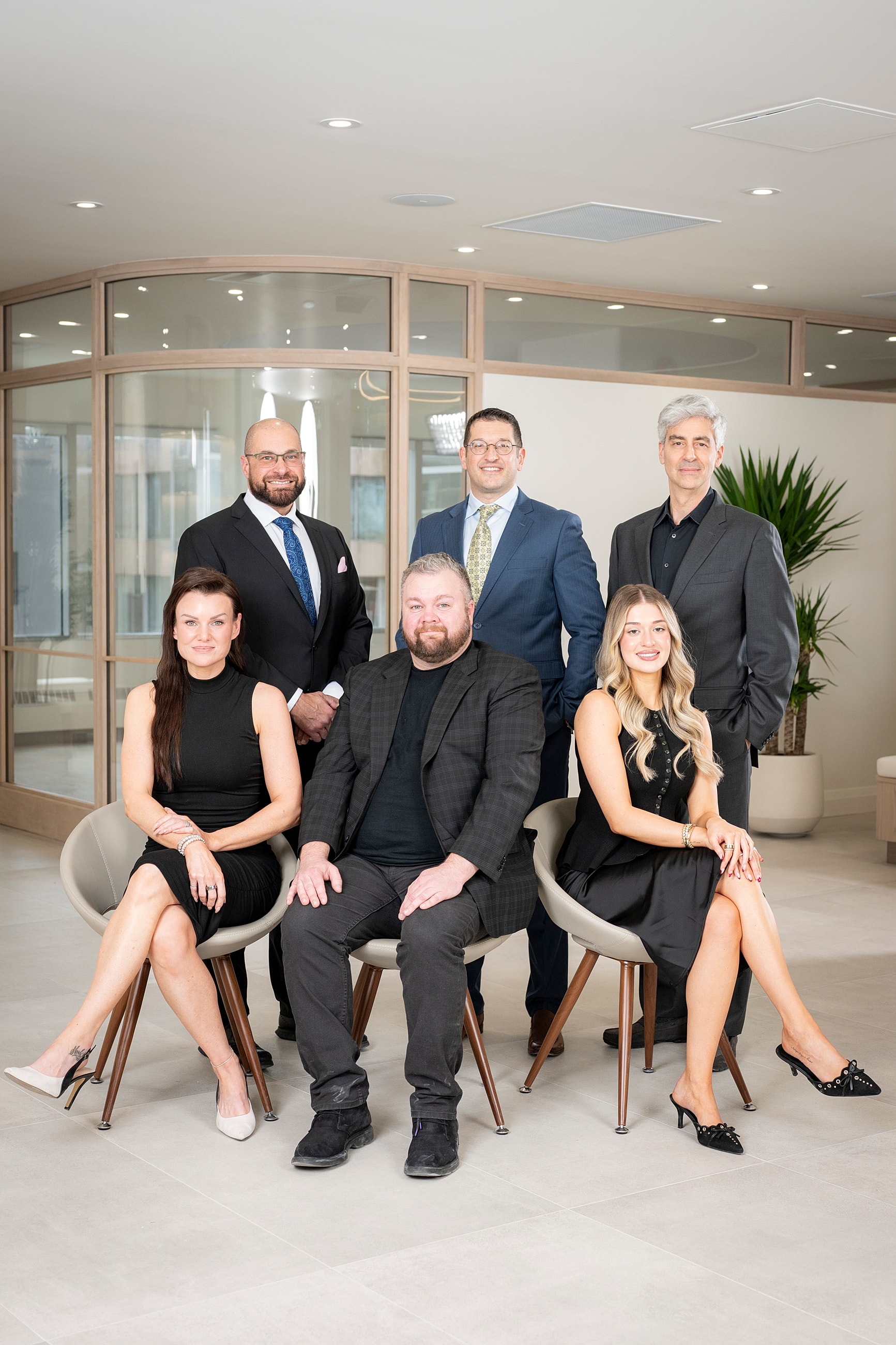 Group portrait of six professionals in office setting.