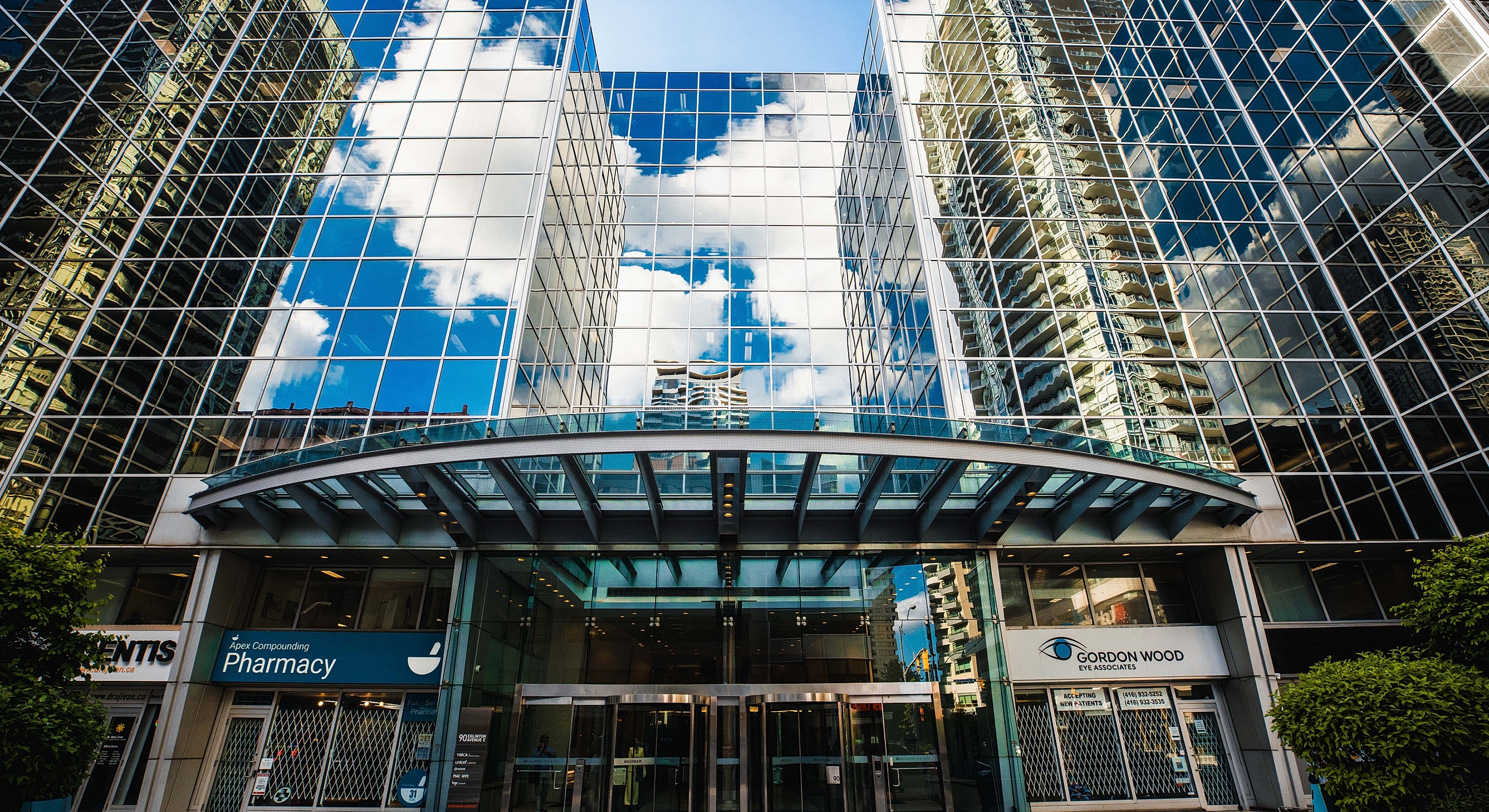 Modern glass building reflecting the sky.