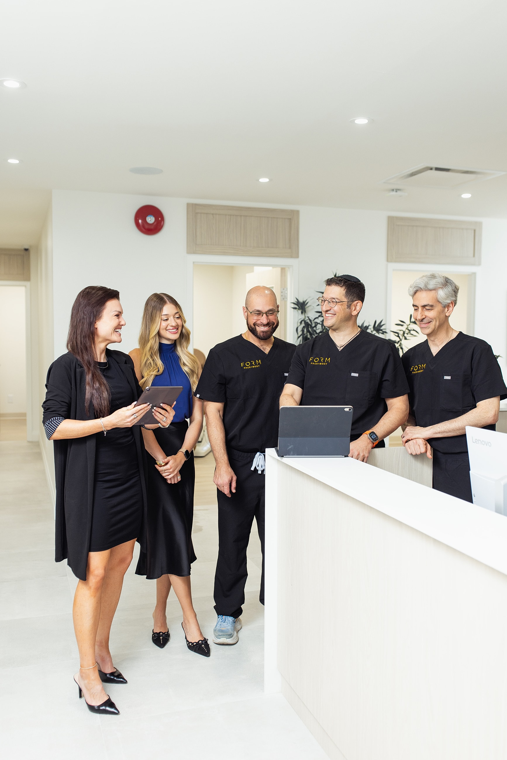 Team discussing at a modern reception desk.