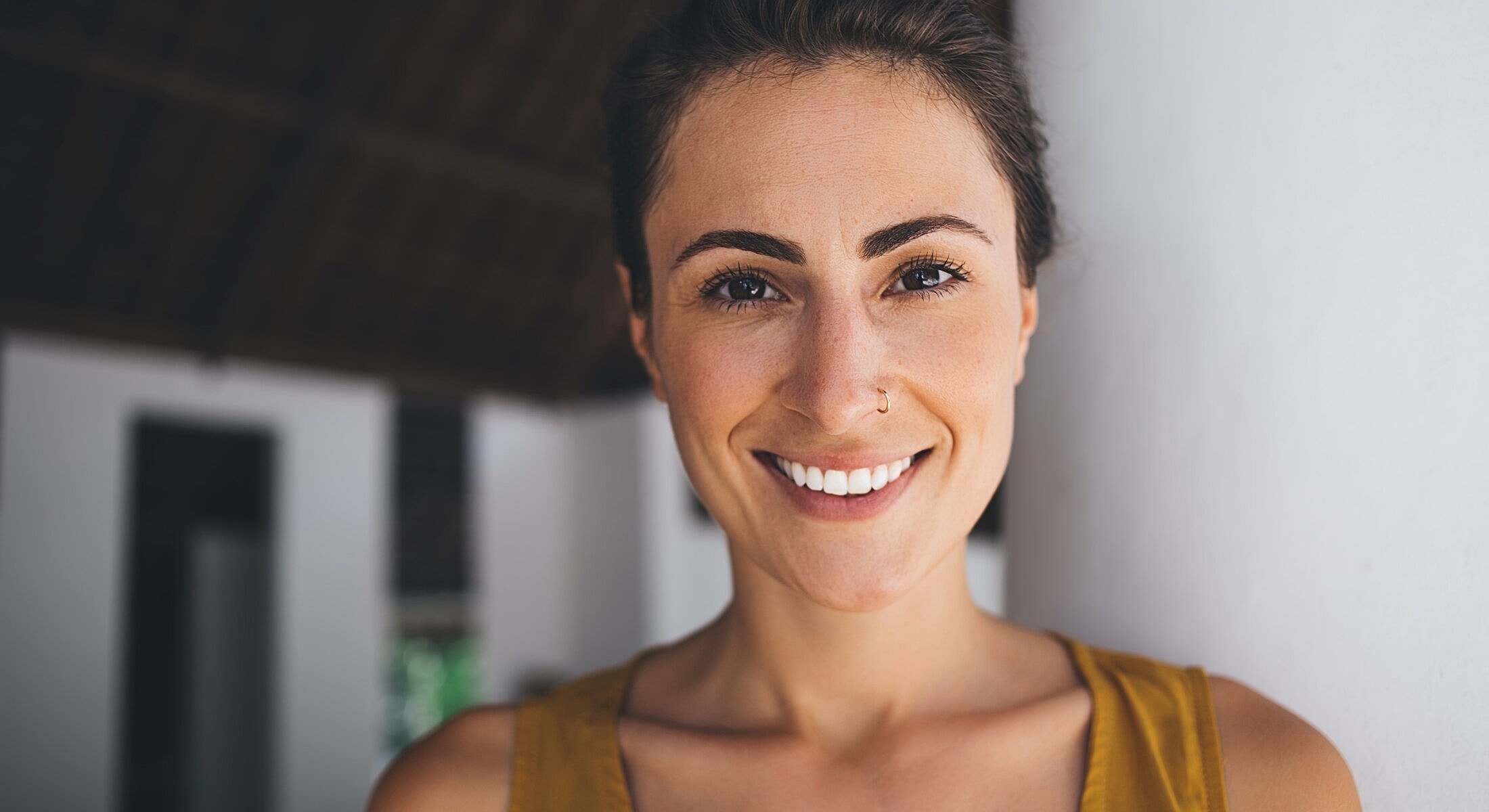 Smiling woman in casual setting, close-up.