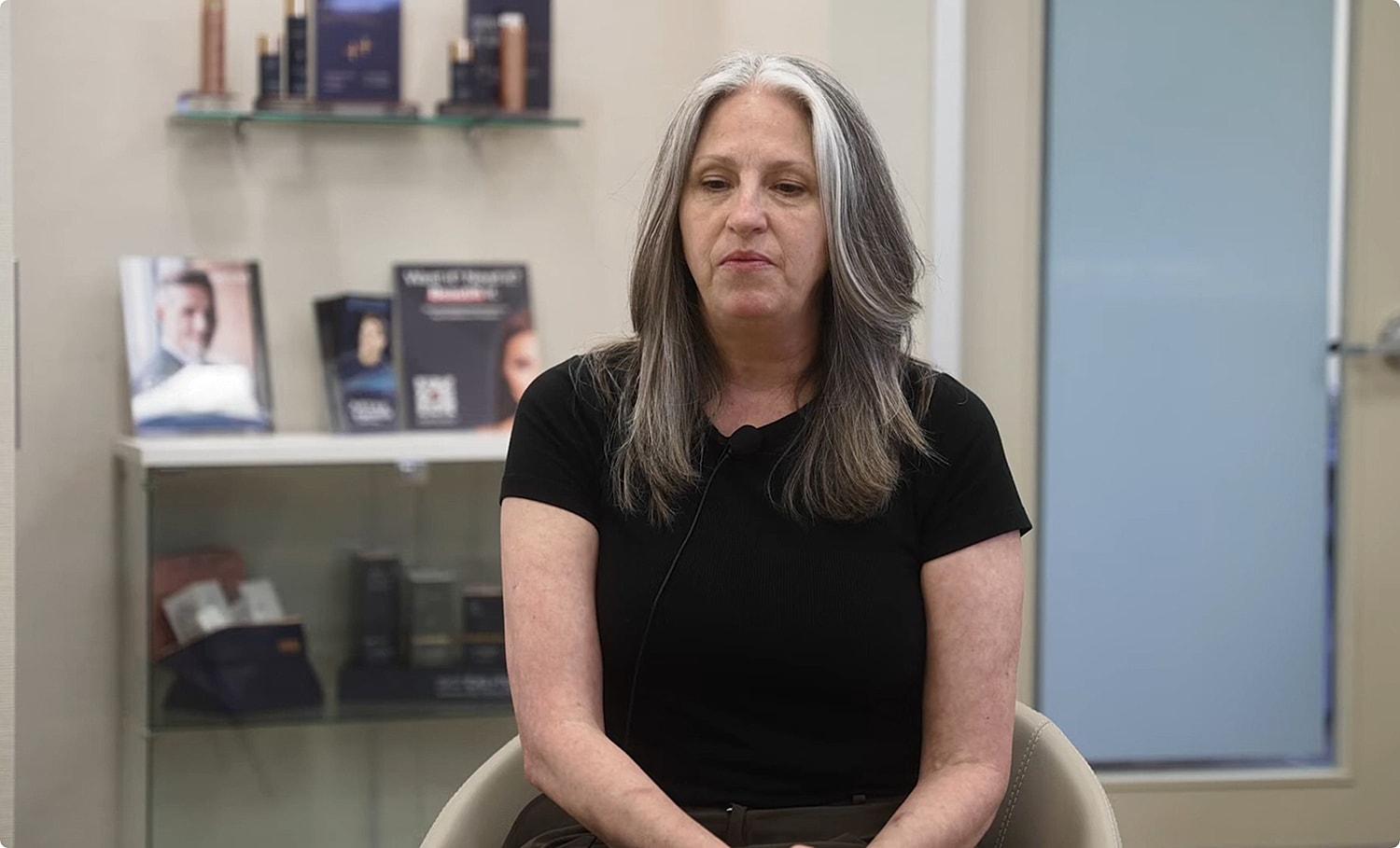 Woman sitting in a beauty salon chair.